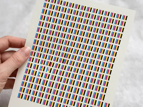A test page with rows of cyan, magenta, yellow and black stripes, one row showing a gap